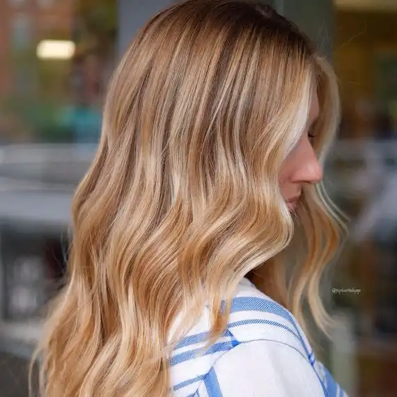 Honey blonde with root melt, the Renaissance golden ideal, made wearable for modern life